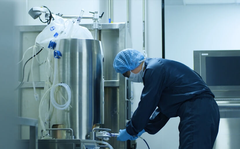 A man in a lab setting up a machine.